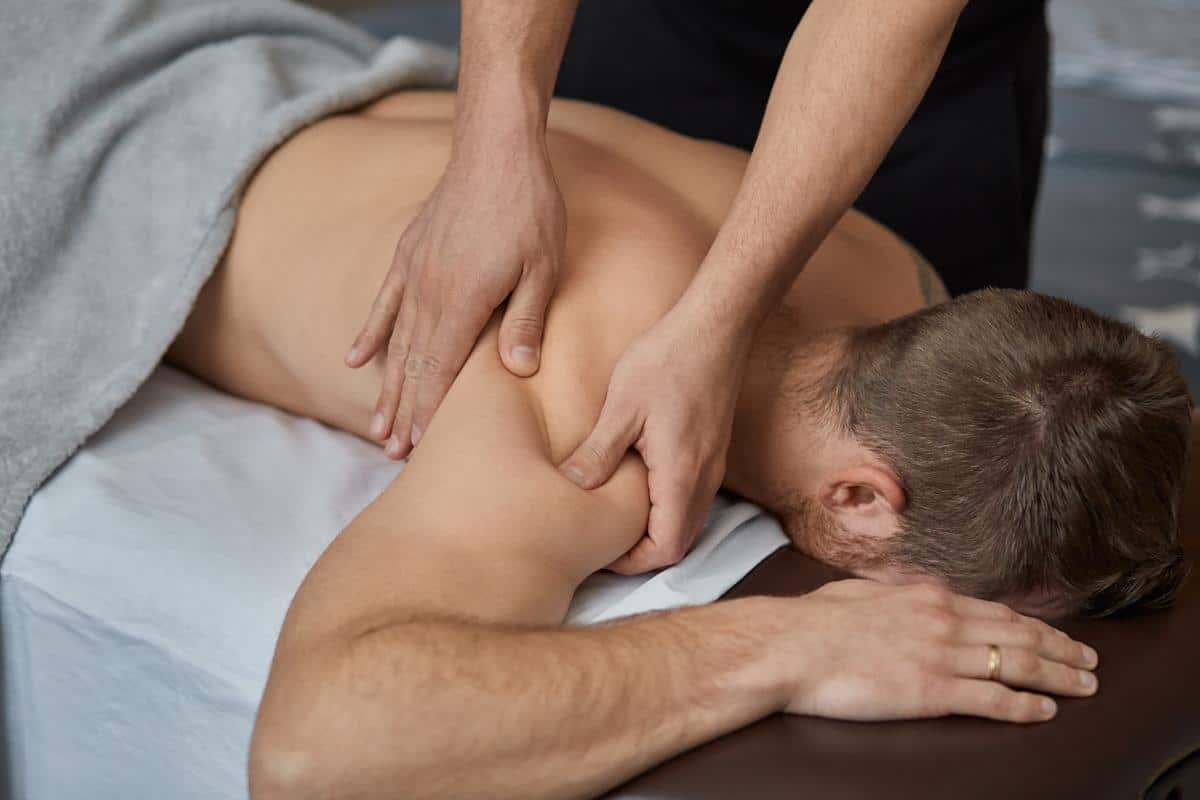 Man-massage-therapy-patient. Jpg Male patient pain treatment stress relief massage therapy