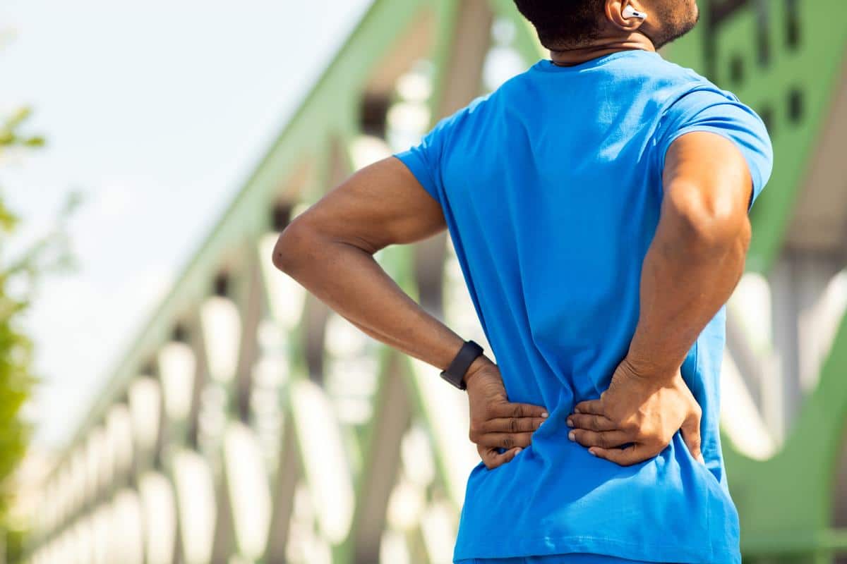 Man-lower-back-pain-outdoors-exercise Cervical & lumbar disc techniques man outdoors in pain after exercising