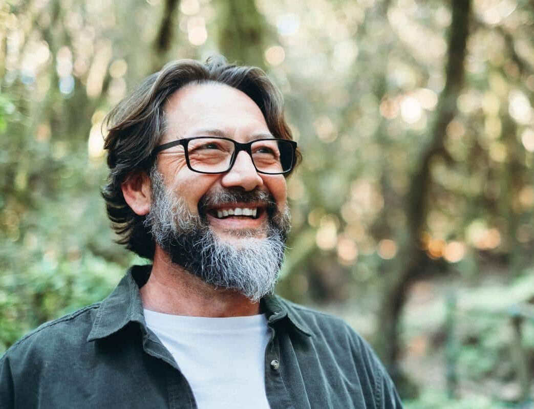 Man-outdoors-happy-healthy-smiling Joyful energetic retired man outdoors smiling